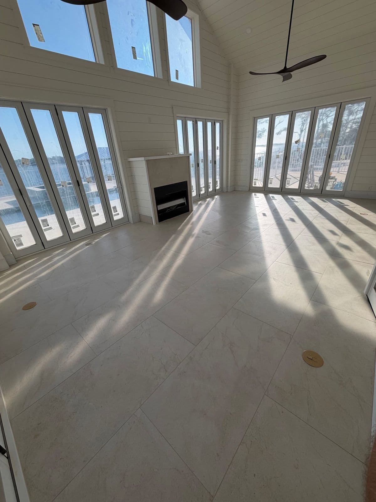 Tile floor installation in Pensacola, FL: large format light porcelain in a waterfront living room in Pensacola, FL