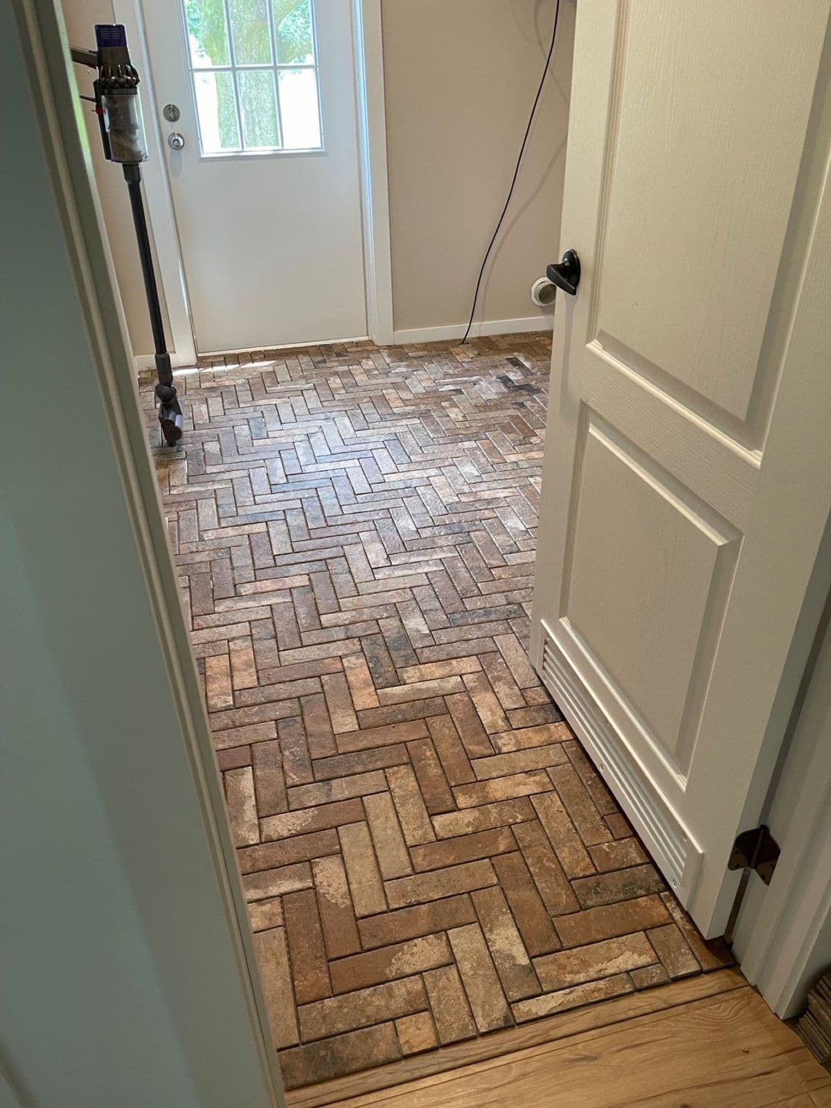 Brick floor installation in Pensacola, FL: herringbone thin brick floor in a mudroom