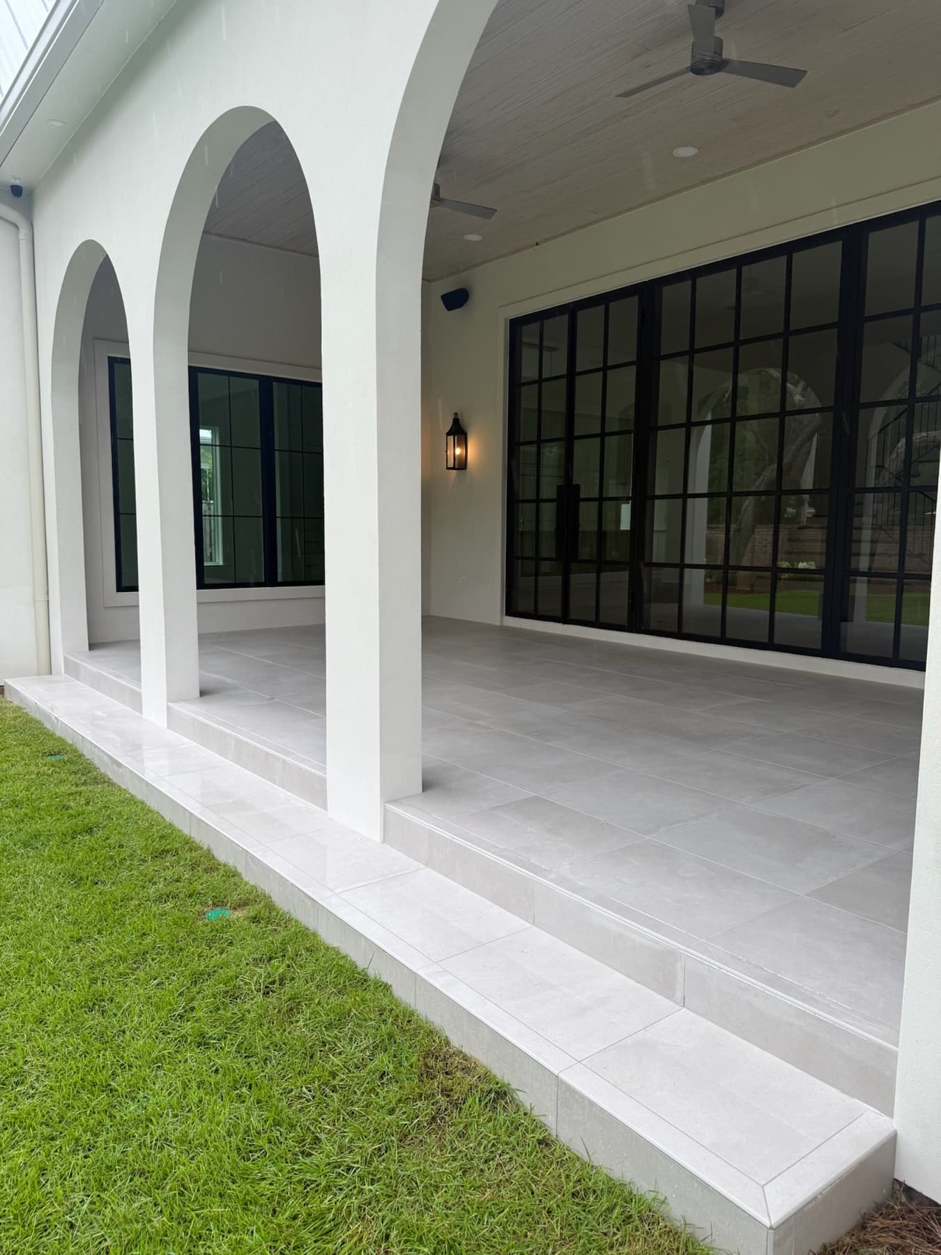 Flooring installation in Pensacola, FL: large format porcelain pavers on a covered patio by Custom Tile & Design